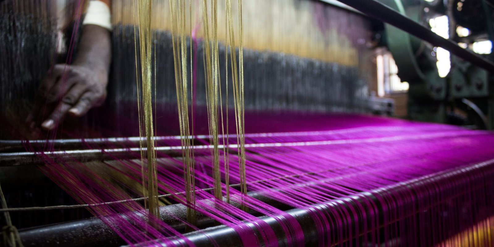 cropped-hand-person-working-loom-factory
